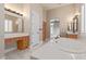 Bathroom with jetted tub, marble floors, dual vanities, and shuttered windows offering natural light at 5576 Buena Martina Way, Las Vegas, NV 89141