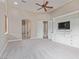 Spacious bedroom with built-in entertainment center, neutral carpet, and ensuite bathroom access at 5576 Buena Martina Way, Las Vegas, NV 89141