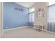 A charming bedroom features a light blue wall and natural light, creating a peaceful and inviting atmosphere at 5576 Buena Martina Way, Las Vegas, NV 89141