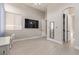 Bedroom featuring tile floors, natural light, a mounted TV, a small mirror, and a walk-in closet at 5576 Buena Martina Way, Las Vegas, NV 89141