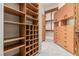 Walk-in closet with custom wooden shelving, drawers, and cabinets for optimal storage and organization at 5576 Buena Martina Way, Las Vegas, NV 89141
