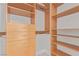 Close-up of custom closet organizers featuring adjustable shelving, drawers, and chrome closet rods at 5576 Buena Martina Way, Las Vegas, NV 89141