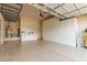 Spacious garage with epoxy flooring, storage cabinets, and workbench area at 5576 Buena Martina Way, Las Vegas, NV 89141
