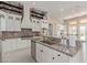 Spacious kitchen with custom cabinetry, stainless appliances, and exposed brick accents at 5576 Buena Martina Way, Las Vegas, NV 89141