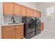 Spacious laundry room with modern washer and dryer, ample counter space, and stylish cabinetry at 5576 Buena Martina Way, Las Vegas, NV 89141