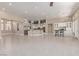 Expansive living room features an open kitchen with modern appliances and white cabinetry at 5576 Buena Martina Way, Las Vegas, NV 89141