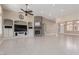 Living room featuring a stone fireplace, built-in shelving, and high ceilings at 5576 Buena Martina Way, Las Vegas, NV 89141