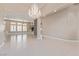 Open-concept living space with stone accent wall, tile flooring, and recessed lighting at 5576 Buena Martina Way, Las Vegas, NV 89141
