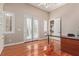 Bright office space with hardwood floors, built-in shelves, and double doors to the exterior at 5576 Buena Martina Way, Las Vegas, NV 89141