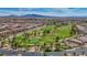 Stunning aerial view of a golf course community, featuring lush greenery, mature trees, and beautiful landscaping at 589 Via Paladini, Henderson, NV 89011