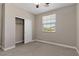 Bedroom featuring a closet with sliding doors, neutral carpet, and a ceiling fan at 589 Via Paladini, Henderson, NV 89011