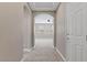 Inviting entryway showcasing elegant archways, neutral paint, and plush carpeting leading to bright windows at 589 Via Paladini, Henderson, NV 89011