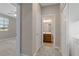 Hallway with carpet, a bathroom and bedroom entrance, and washer and dryer closet at 589 Via Paladini, Henderson, NV 89011