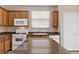 Updated kitchen showcasing stainless steel appliances, granite countertops, and ample cabinet space at 589 Via Paladini, Henderson, NV 89011