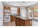 Well-equipped kitchen boasting stainless steel appliances, center island, and convenient access to the patio at 589 Via Paladini, Henderson, NV 89011
