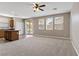 Open concept living and dining space featuring large windows and seamless flow to the kitchen at 589 Via Paladini, Henderson, NV 89011