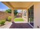 Covered brick patio leading to a small grass yard at 589 Via Paladini, Henderson, NV 89011