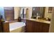 Well-lit bathroom featuring a soaking tub, double vanity with granite counters and a separate shower at 5941 Alington Bend Dr, Las Vegas, NV 89139