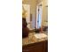 Bathroom featuring a decorative mirror, granite countertops, and bronze fixtures at 5941 Alington Bend Dr, Las Vegas, NV 89139
