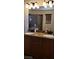 Bathroom with granite counters and double sinks in a modern, well-lit space, with a shower visible in the mirror at 5941 Alington Bend Dr, Las Vegas, NV 89139