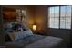 Cozy bedroom featuring a plush bed with soft lighting, art, and view to the neighborhood at 5941 Alington Bend Dr, Las Vegas, NV 89139