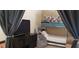 Bedroom featuring curtains, a bunk bed with trundle, a small sofa, and TV at 5941 Alington Bend Dr, Las Vegas, NV 89139