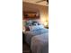 Bedroom with comfy looking bed, bedside lamp, and wood blinds allowing natural light at 5941 Alington Bend Dr, Las Vegas, NV 89139