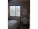 Comfortable bedroom with a chair and table underneath the window at 5941 Alington Bend Dr, Las Vegas, NV 89139