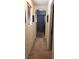 Hallway leading to a bathroom featuring an arched doorway and natural light at 5941 Alington Bend Dr, Las Vegas, NV 89139