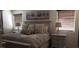 Relaxing main bedroom with neutral tones, patterned bedding, art, and natural lighting at 5941 Alington Bend Dr, Las Vegas, NV 89139