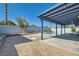Expansive backyard with a large covered patio, pool, and landscaping at 6309 Miraloma St, Las Vegas, NV 89108
