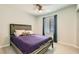A bedroom with a full-sized bed, a ceiling fan, and natural light at 6309 Miraloma St, Las Vegas, NV 89108