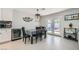 Dining area featuring modern lighting, a table with chairs, and convenient access to the backyard at 6309 Miraloma St, Las Vegas, NV 89108