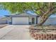 Inviting single-story home with a two-car garage, complemented by mature landscaping and blue accents at 6309 Miraloma St, Las Vegas, NV 89108