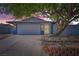 Inviting single-story home with a two-car garage, complemented by mature landscaping and colorful sky at 6309 Miraloma St, Las Vegas, NV 89108