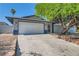Charming single-story home with a two-car garage and a well-maintained front yard at 6309 Miraloma St, Las Vegas, NV 89108