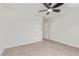 Neutral bedroom with carpet, white walls, ceiling fan, and two doors at 659 D Ave, Boulder City, NV 89005