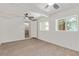 Bright, carpeted bedroom features two windows for natural light at 659 D Ave, Boulder City, NV 89005