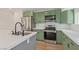 Well-equipped kitchen boasts stainless steel appliances and modern green cabinetry at 659 D Ave, Boulder City, NV 89005