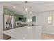 Bright kitchen features stainless steel appliances, a large island, and stylish green cabinets at 659 D Ave, Boulder City, NV 89005