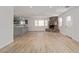 Spacious living room with a stone fireplace and modern light wood flooring at 659 D Ave, Boulder City, NV 89005