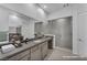 Bright bathroom with double sink vanity and large walk-in glass shower at 6684 Regency Stone Way, Las Vegas, NV 89148