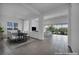 Bright, virtually staged dining area with tile floors and view into staged living room at 6684 Regency Stone Way, Las Vegas, NV 89148