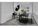 Bright dining room features a dark wood table, console table, and modern art at 6684 Regency Stone Way, Las Vegas, NV 89148