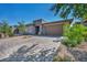 The house displays an attached garage, manicured front yard, and stone accents at 6684 Regency Stone Way, Las Vegas, NV 89148