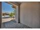 Inviting covered front porch with stone paver flooring and desert landscape at 6684 Regency Stone Way, Las Vegas, NV 89148