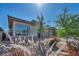 A cozy home exhibits professionally manicured landscaping and a modern architectural design at 6684 Regency Stone Way, Las Vegas, NV 89148