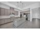 Modern kitchen features gray cabinets, a center island with seating, and stainless appliances at 6684 Regency Stone Way, Las Vegas, NV 89148