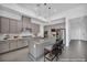 Modern kitchen features gray cabinets, a center island with seating, and stainless appliances at 6684 Regency Stone Way, Las Vegas, NV 89148