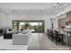 Open living space flows to patio, featuring modern furnishings and recessed lighting at 6684 Regency Stone Way, Las Vegas, NV 89148